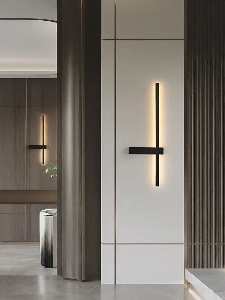 Modern black and gold led wall lamp with minimalist black wall sconce design emitting warm ambient light