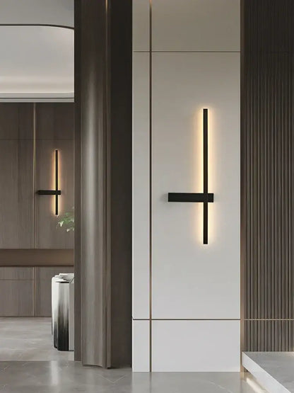 Modern black and gold led wall lamp with minimalist black wall sconce design emitting warm ambient light