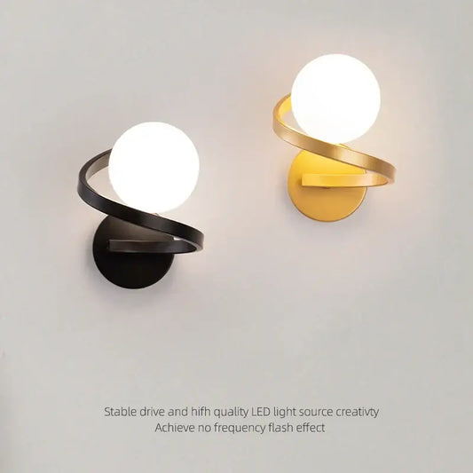 Modern black and gold led wall lights with sleek spiraling metal arms and frosted glass shades by decorbites black copper