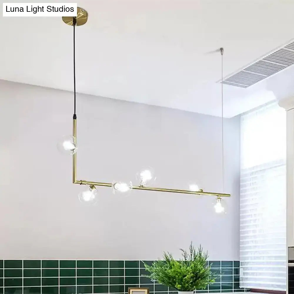Modern black gold linear chandelier with brass pendant lights and clear glass globe bulbs for dining room island lighting