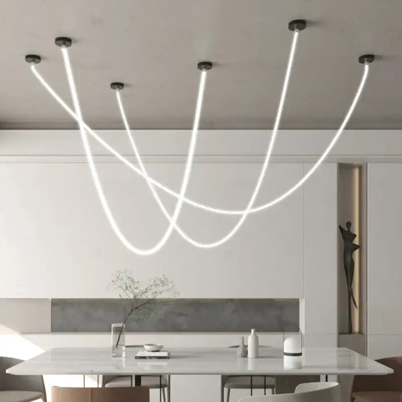 Modern white led pendant light with sleek curved strands suspended from black fixtures as an elegant dining room light source