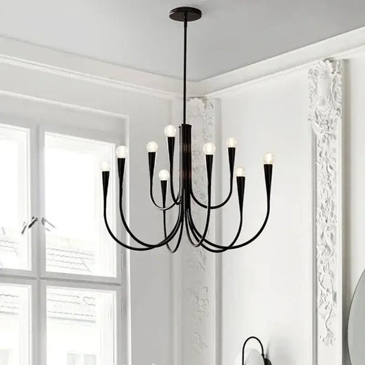 Modern black gold metal chandelier with nine curved arms and frosted glass bulbs by decorbites gold metal