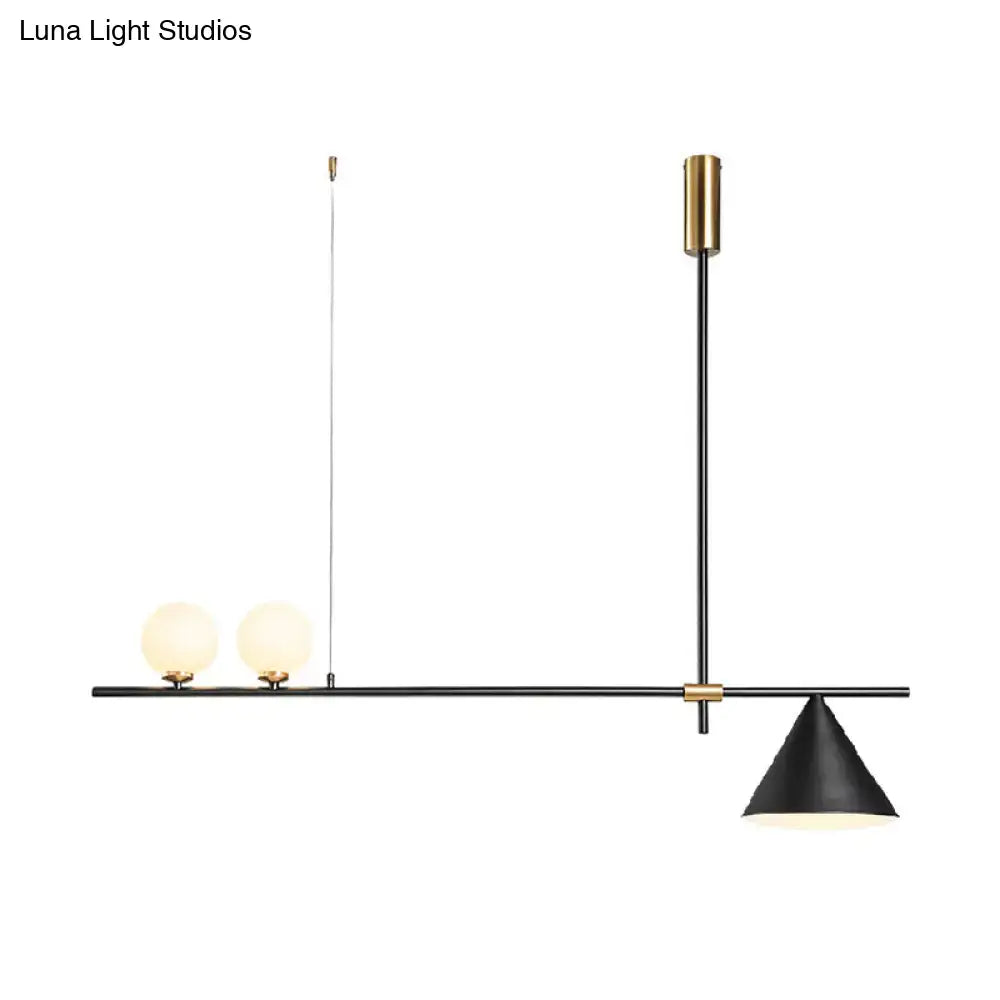 Modern black and gold metal cone island light featuring brass accents with two glass bulbs and a conical shade for dining room