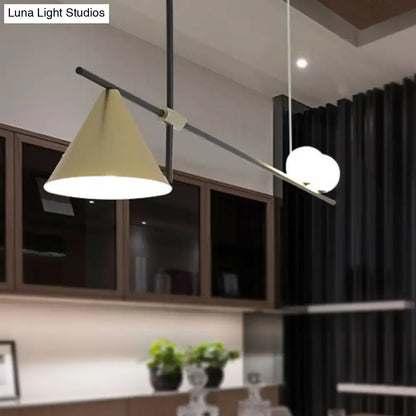 Modern black and gold metal cone island light with beige conical shade and two white spherical bulbs for dining room