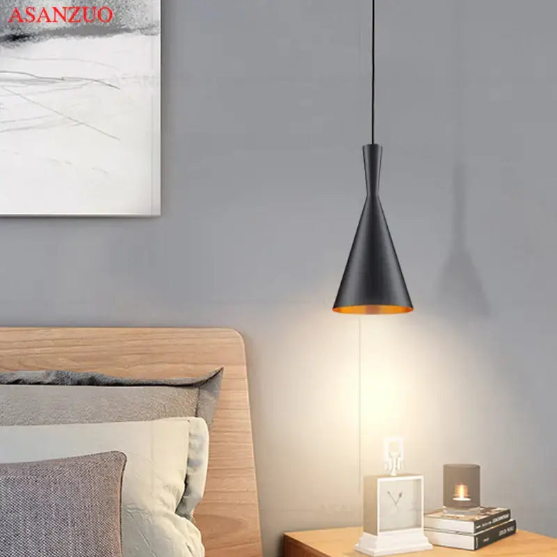 Modern black and gold musical pendant light with conical shape and warm gold interior lining for dining room lighting