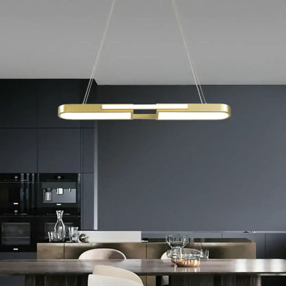 Modern gold-toned oblong acrylic pendant light with integrated led warm white lighting for dining room use