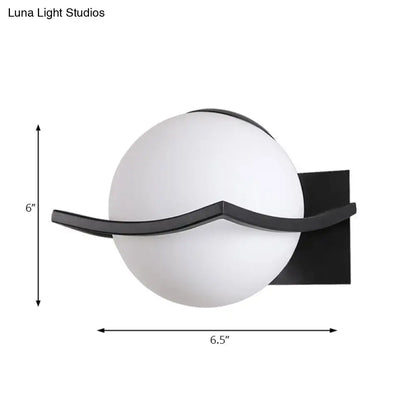 Modern black and white wall sconce with opal glass globe and curved metal accent for bedroom led incandescent fluorescent use