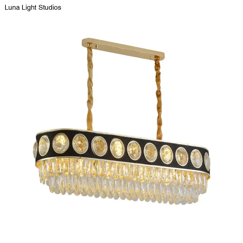 Decorbites modern oval island light featuring gold-toned oval chandelier with black trim and clear glass prisms