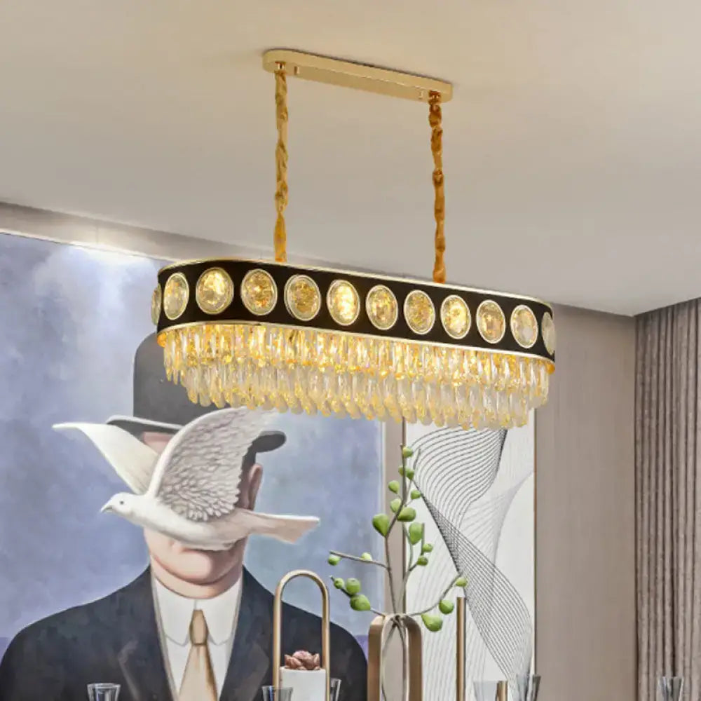 DecorBites™ modern oval island light in gold tone with black frame and clear crystal droplets for hanging over table