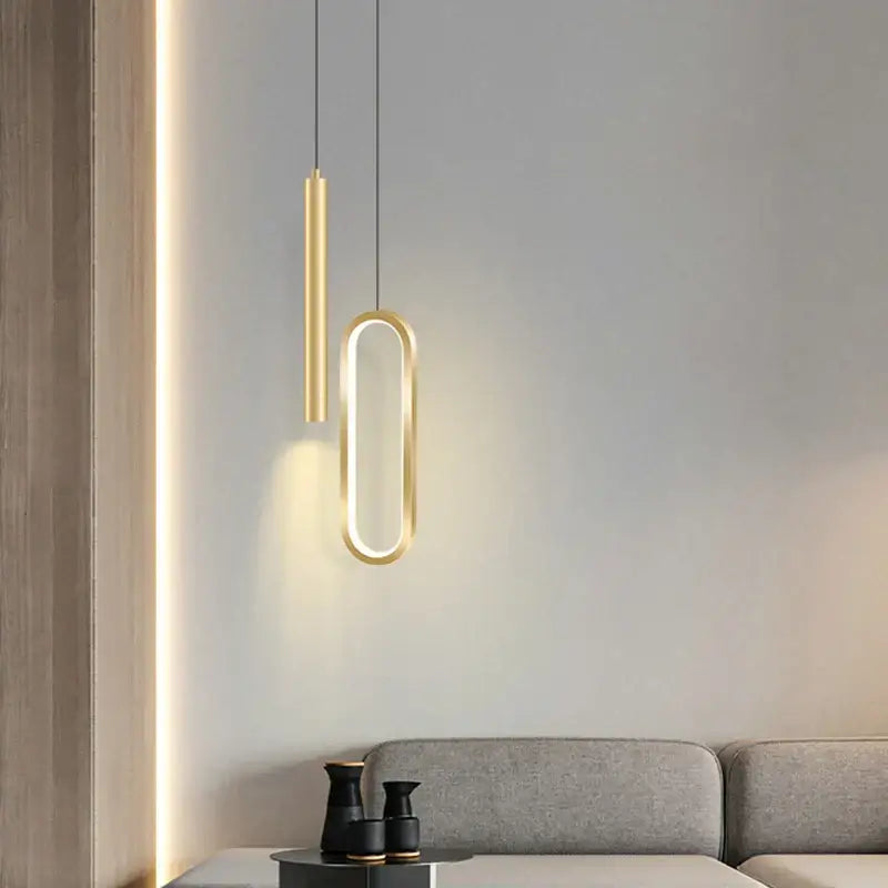 Modern black and gold oval pendant light with white light source featuring sleek minimalist gold-toned design