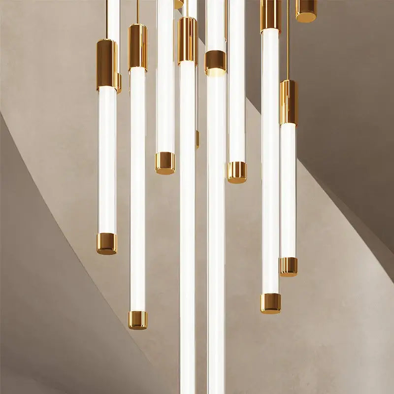 Modern black and gold pendant chandelier featuring sleek white cylindrical glass tube pendant lights for staircase light sources