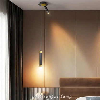 Modern black and gold cylindrical pendant light with warm focused light sources for stylish modern interiors