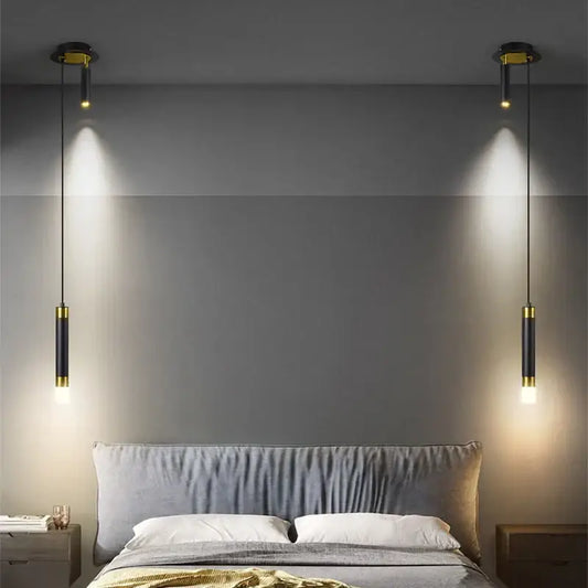 Modern black and gold pendant light with dual spotlights as stylish light sources for modern interiors above bed