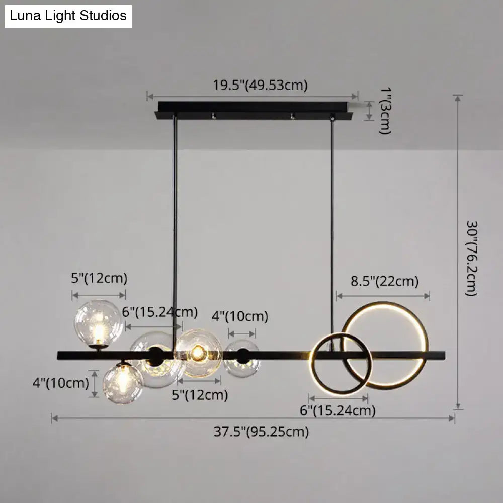 Modern black metal chandelier with clear glass spheres and gold-toned rings for dining room pendant lighting
