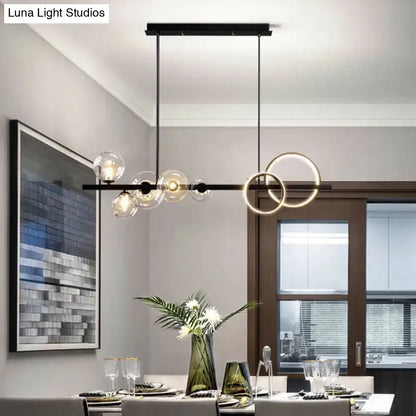 Modern black metal chandelier with clear glass spheres and glowing circular rings for dining room pendant light
