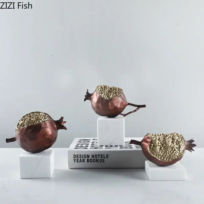 Modern black and gold pomegranate sculpture set featuring bronze decorbites golden pomegranate figurines with textured interiors