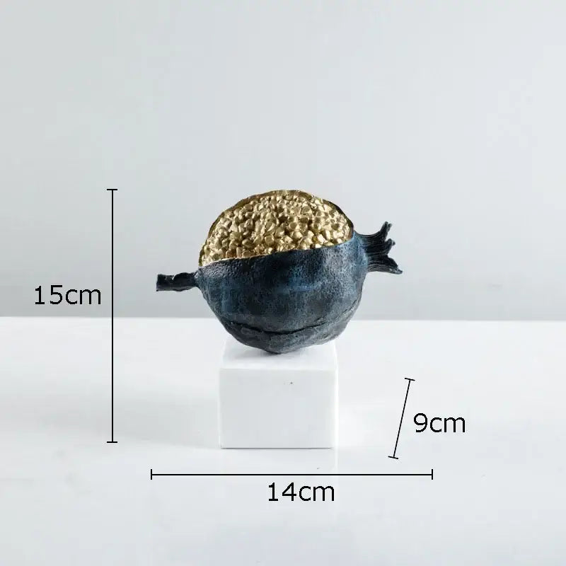 A sleek 15cm tall modern black and gold pomegranate sculpture with textured interior for living room decorbites golden pomegranate decor