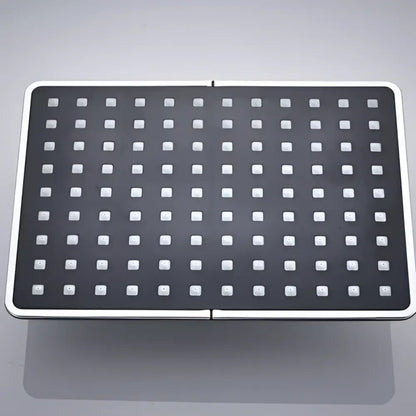 Modern black rainfall shower head with white square nozzles and sleek silver metallic frame for bathroom use