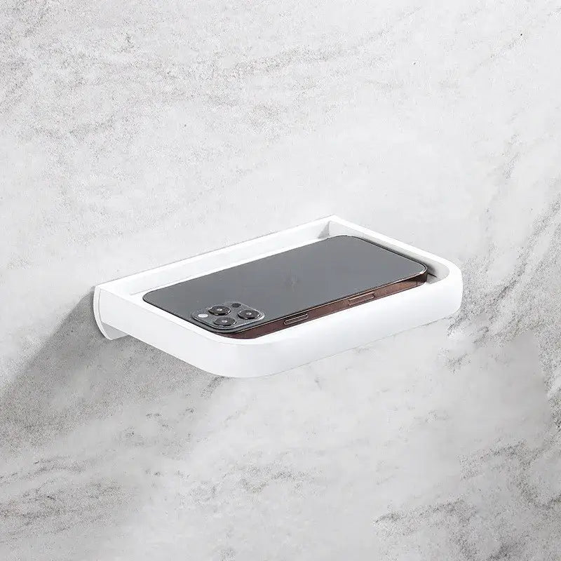 Modern black and gold tissue paper holder with white plastic wall-mounted phone tray for bathroom organization