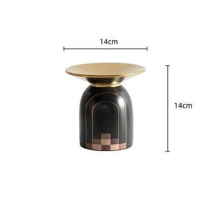 A sleek black and gold accent table with polished brass top and wood inlay for modern decorbites golden tray vase decor