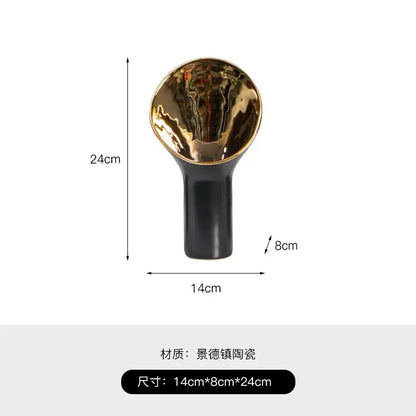 A sleek modern black and gold trumpet ceramic flower vase with glossy base and reflective golden trumpet ceramic interior decorbites