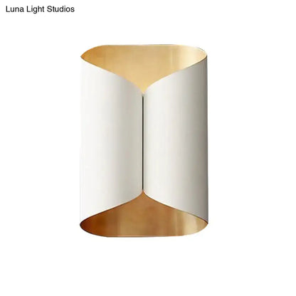 Modern black and gold twisted light fixture porch wall sconce with sleek curved exterior and warm gold bulb base lining