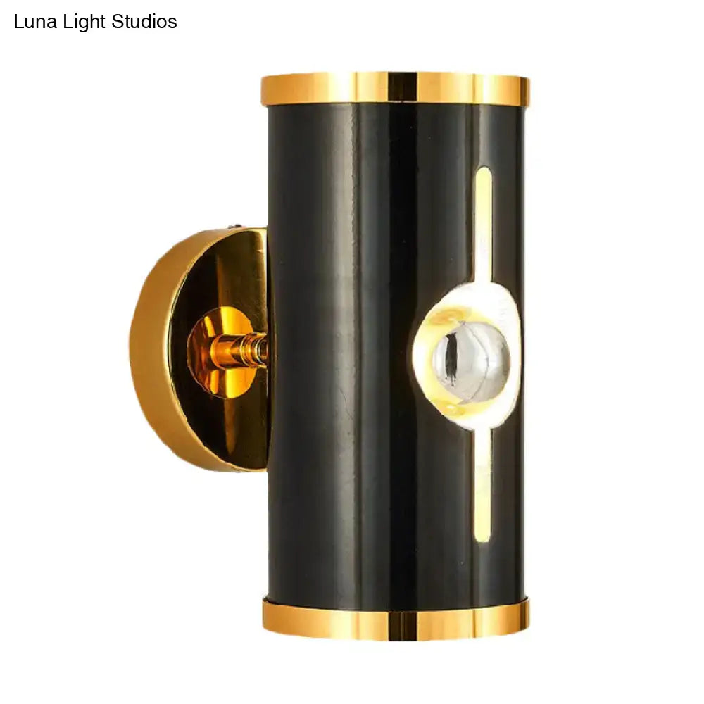 Modern black and gold wall lamp with black finish cylindrical design and vertical light strip for bedroom sconce lighting