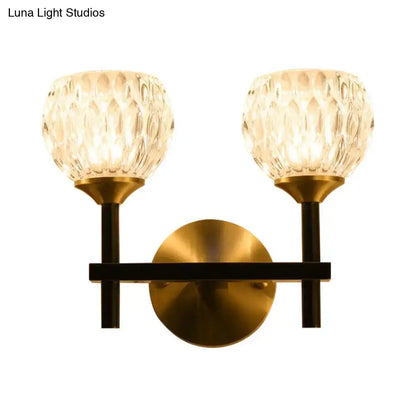 Brass-finished wall light with two faceted dimpled glass shades for stylish living room illumination