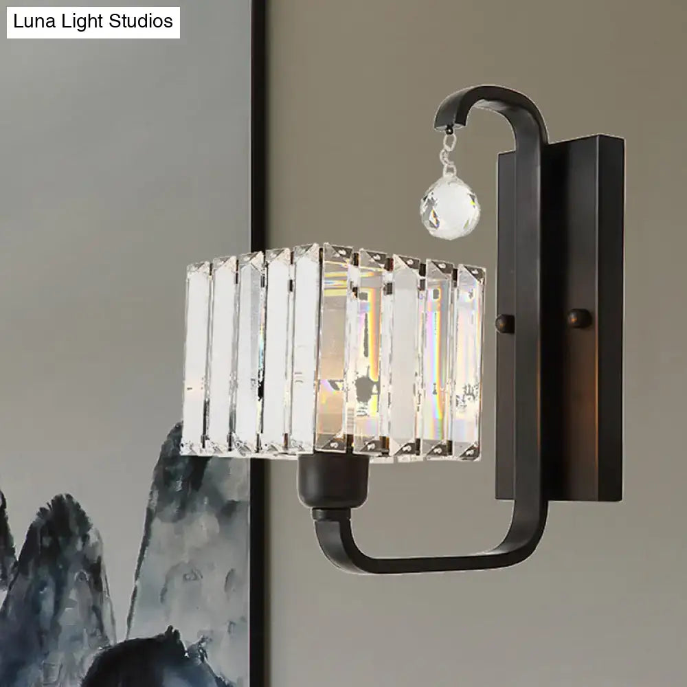 Modern black metal wall sconce with rectangular crystal shade cage and dangling faceted crystal pendant for living room wall lamp