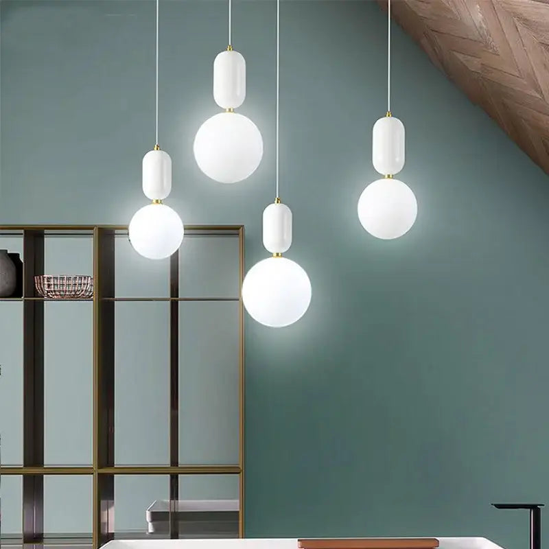 Modern black gold and white glass ball led chandelier featuring white pendant lights with frosted glass globes and gold accents