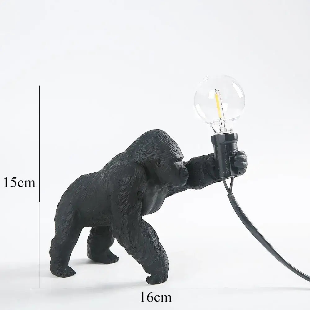 Modern black gorilla night light made of resin with a textured matte finish holding an exposed filament bulb for decorbites gorilla night