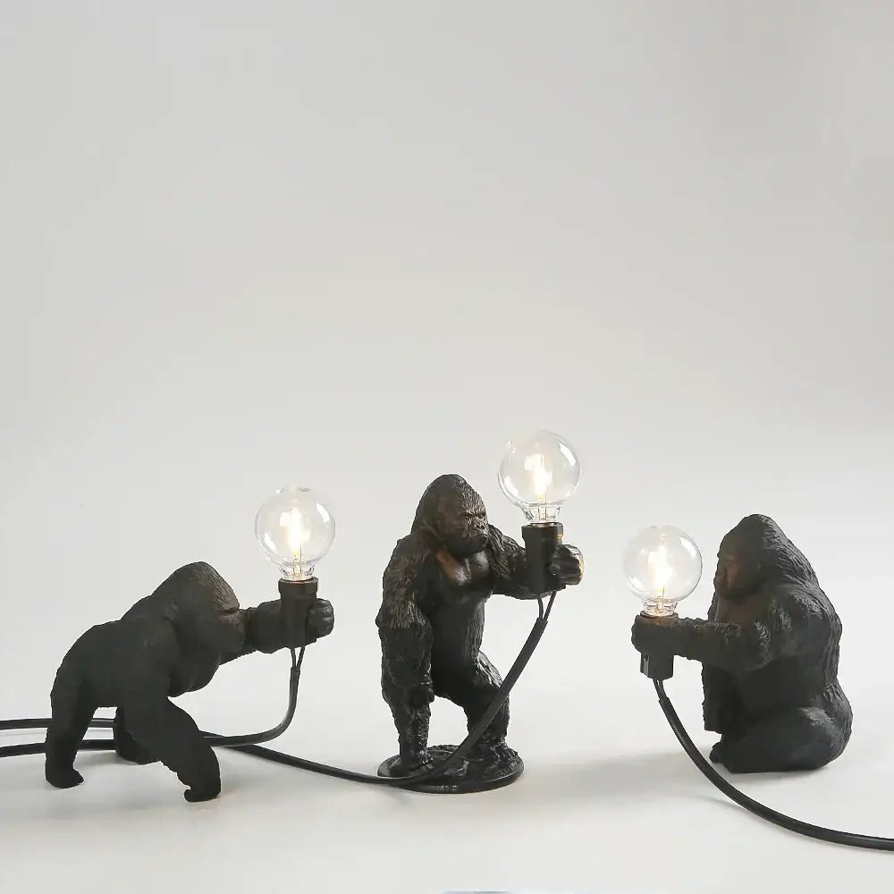 Three black resin gorilla figurine lamps holding glowing bulbs modern decorbites gorilla night light for bedroom