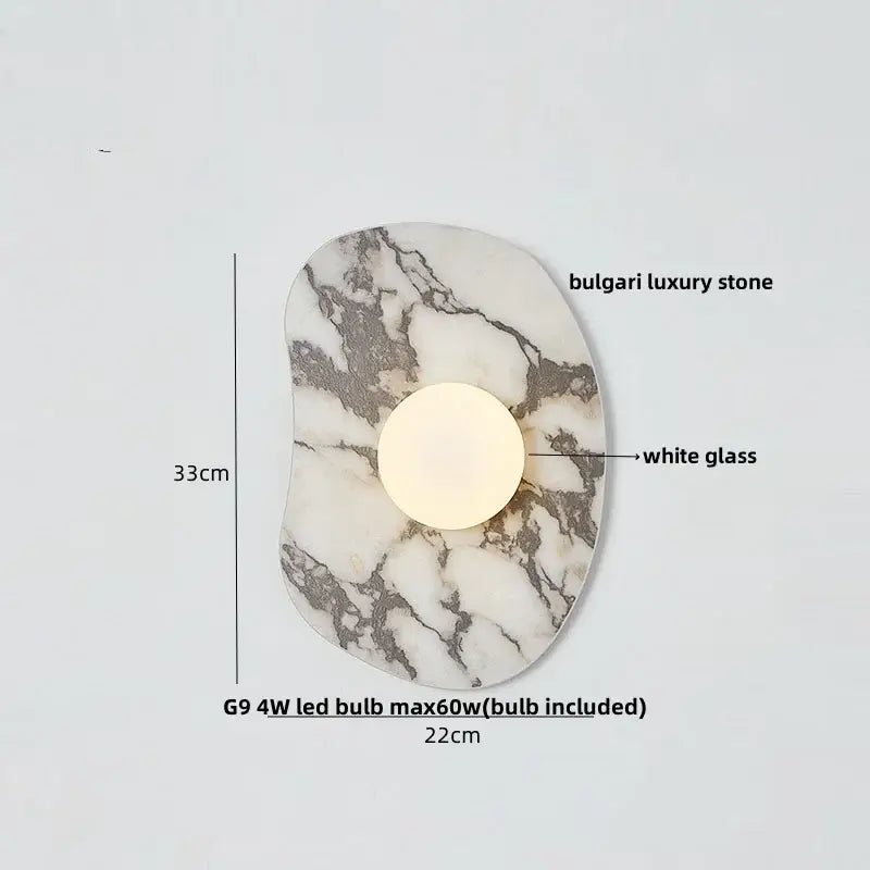 Modern wall sconce with a circular white glass bulb set in irregular decorbites green marble stone base for bedroom use