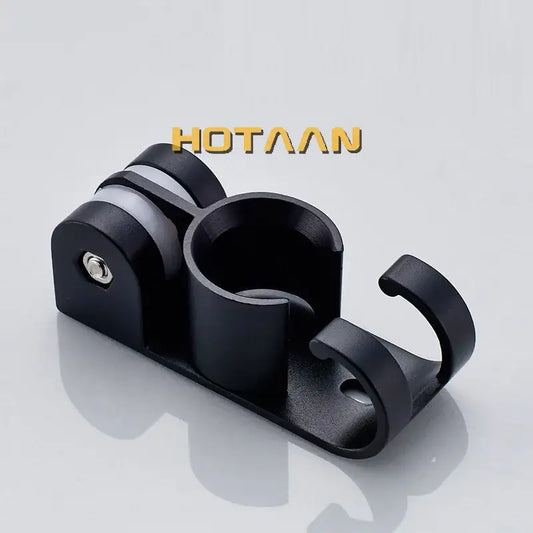Modern black hand shower holder wall mount bracket with multi-hook organizer and central cup with silver screw detail