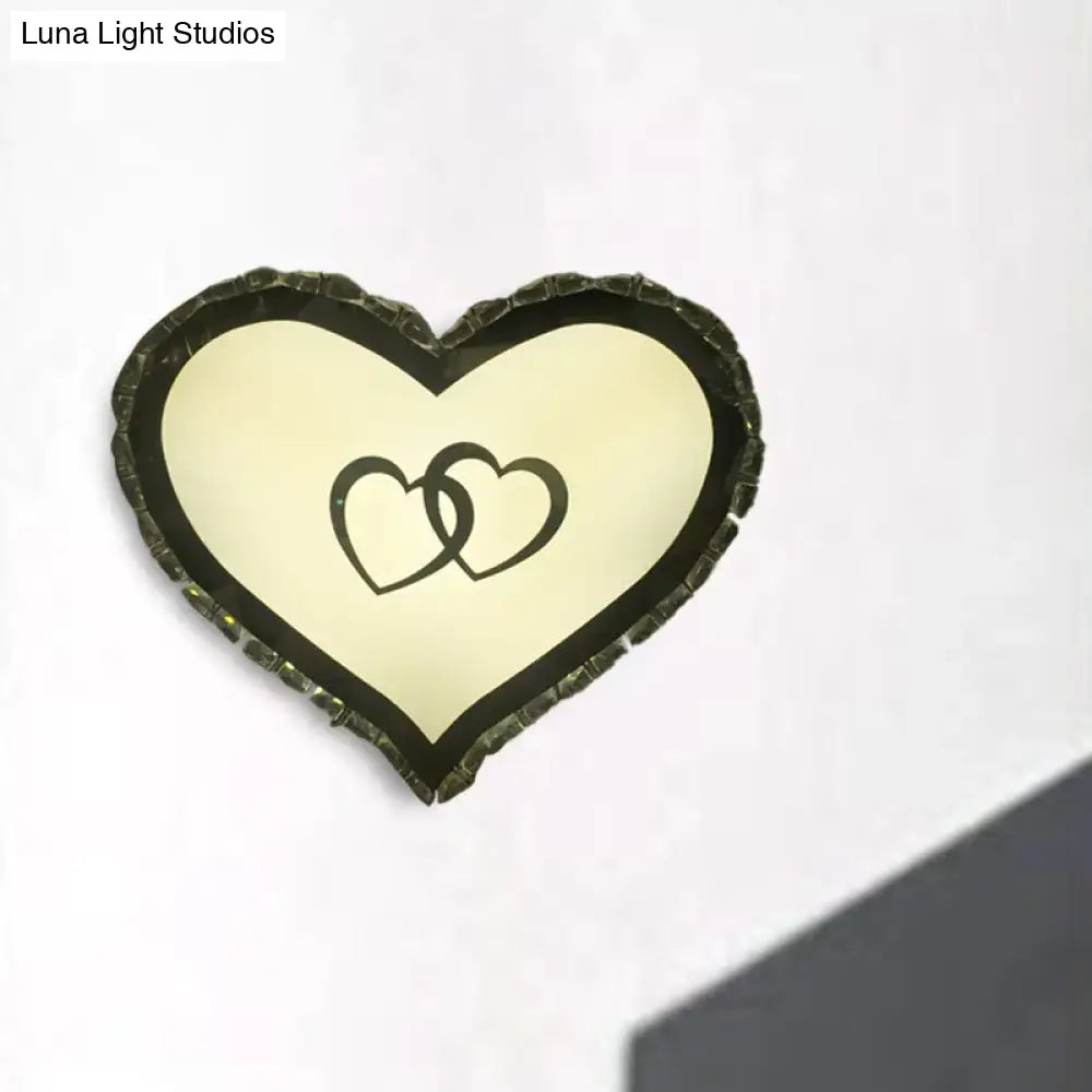 Modern black heart crystal shade wall sconce with textured frame and interlocking hearts design for bedroom lighting