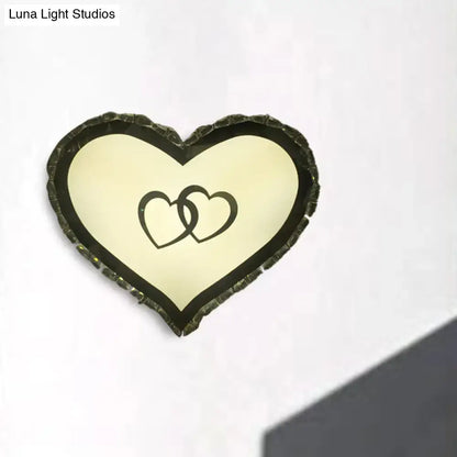 Modern black heart crystal shade wall sconce with textured frame and interlocking hearts design for bedroom lighting