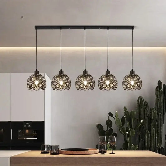 Modern black iron cage pendant lamp with intricate circular design hanging above kitchen island lighting decorbites crystal dining