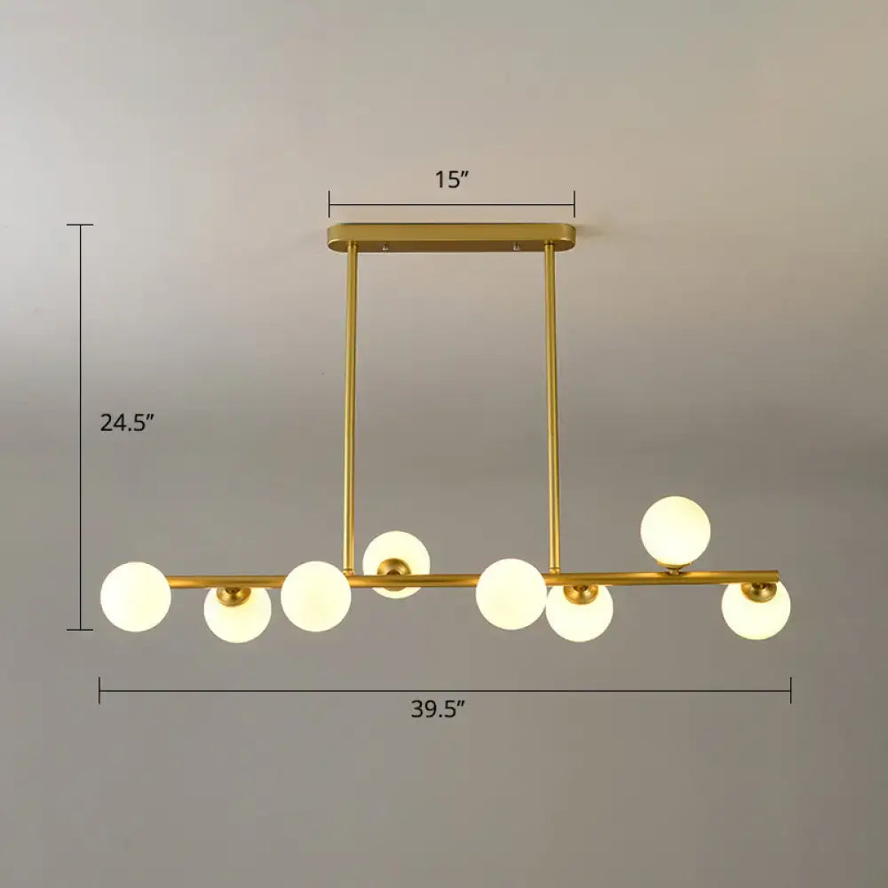 Decorbites modo island ceiling light with gold-toned bar and seven frosted glass globes for dining room lighting