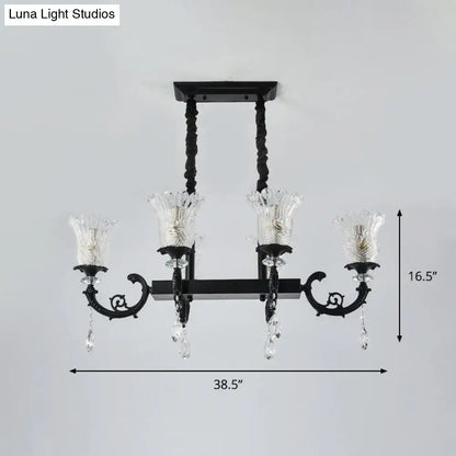 Black wrought iron island pendant lamp with clear crystal droplets and glass candle-style shades for dining room