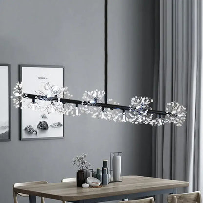 Modern black island pendant light with crystal dandelion clusters hanging above a dining room table