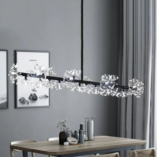 Modern black island pendant light with crystal dandelion clusters hanging above a dining room table