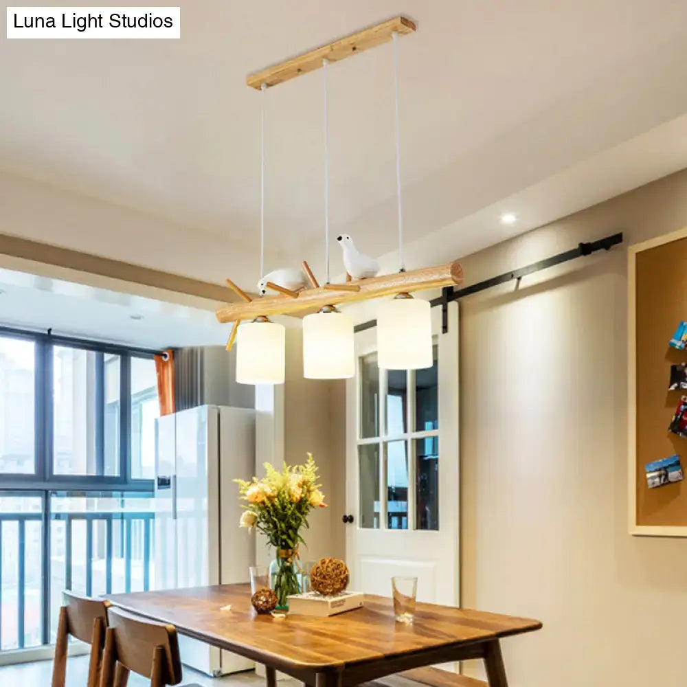 Decorbites™ modern island pendant light with frosted glass cylindrical lampshades and rustic wood beam with bird figurines