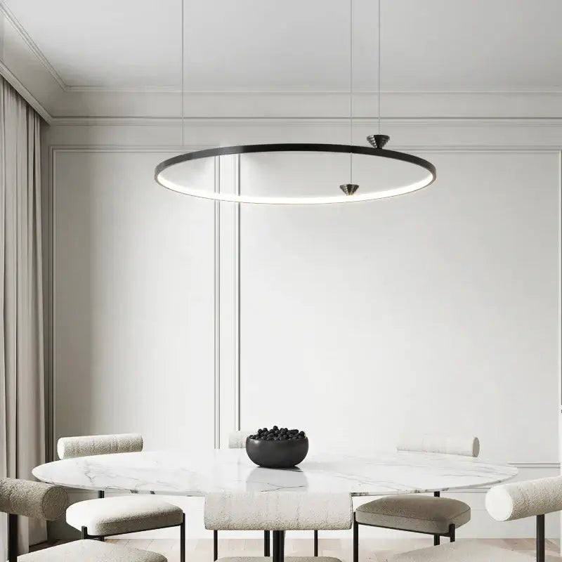 Modern black italian style led pendant light with sleek minimalist design hanging above dining table