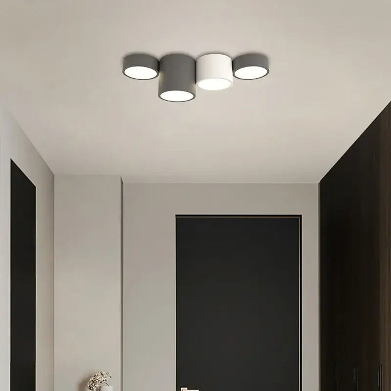 Modern black led ceiling lamp with two matte gray and one white cylindrical shades for contemporary living room lighting