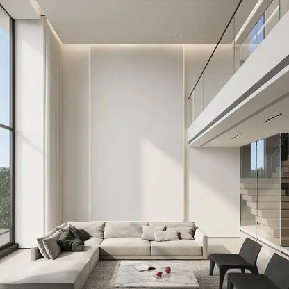 A modern black led grille downlight recessed spot light shown above a sleek off-white sectional sofa with plush cushions