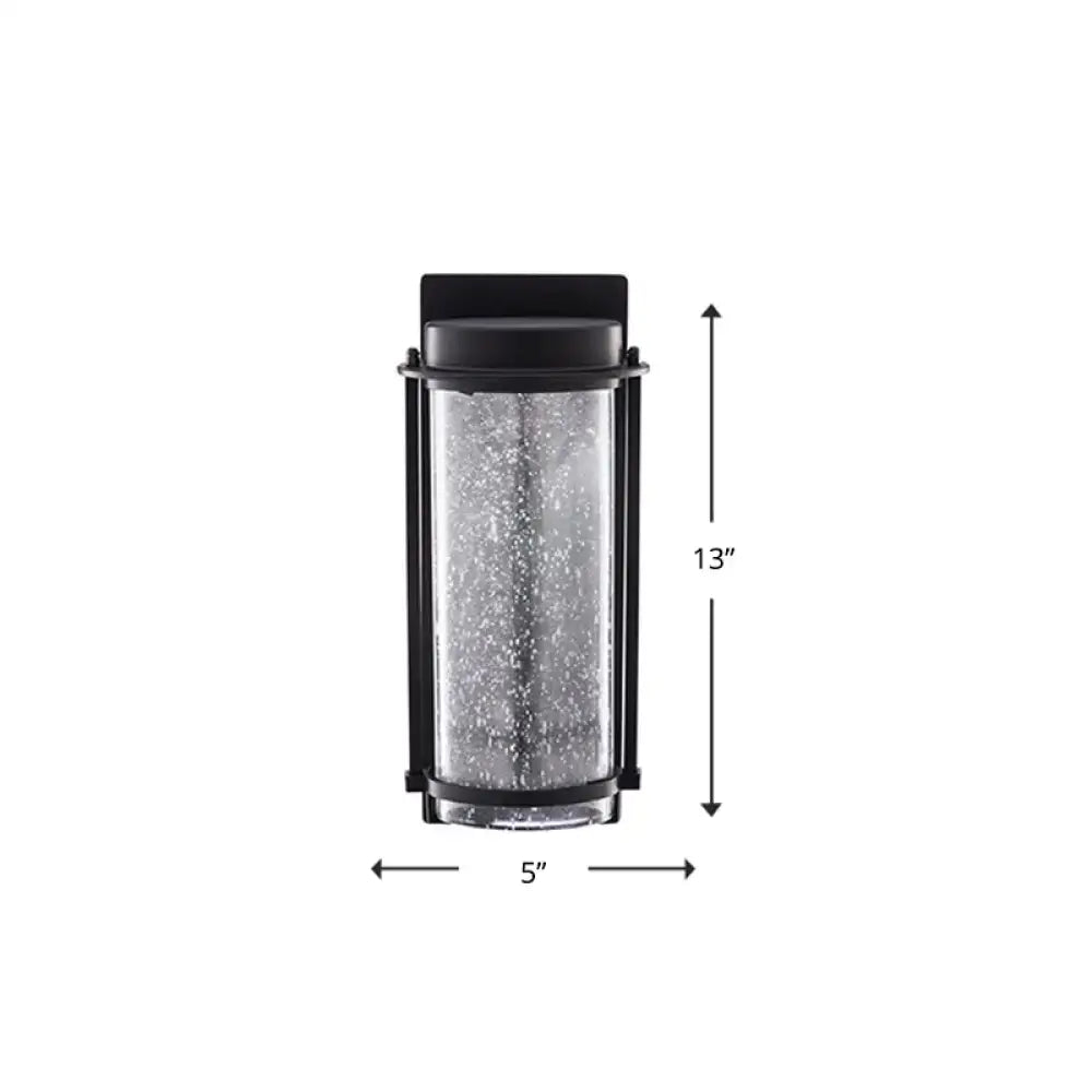 Modern black led outdoor wall sconce featuring a black frame and textured speckled rippled glass cylinder