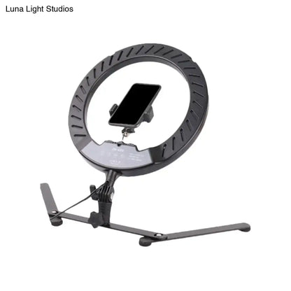 Modern black led ring flash lamp with metallic shade and bulb included featuring a phone mount on its stand