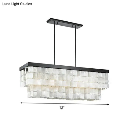 Black metal rectangular island light fixture with layered translucent white shell panels for modern living rooms