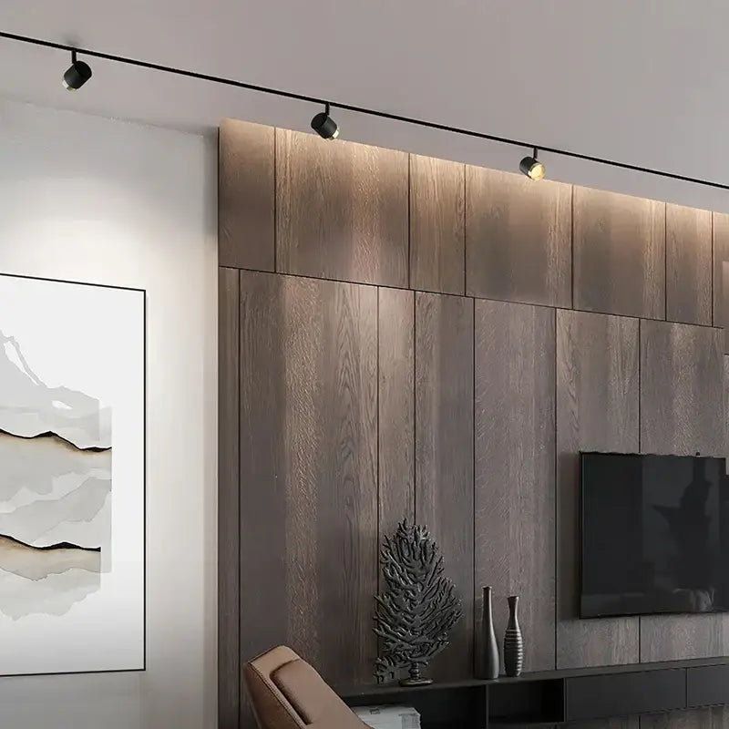 Modern black led track spotlight with three adjustable spotlights mounted on a kitchen ceiling rail