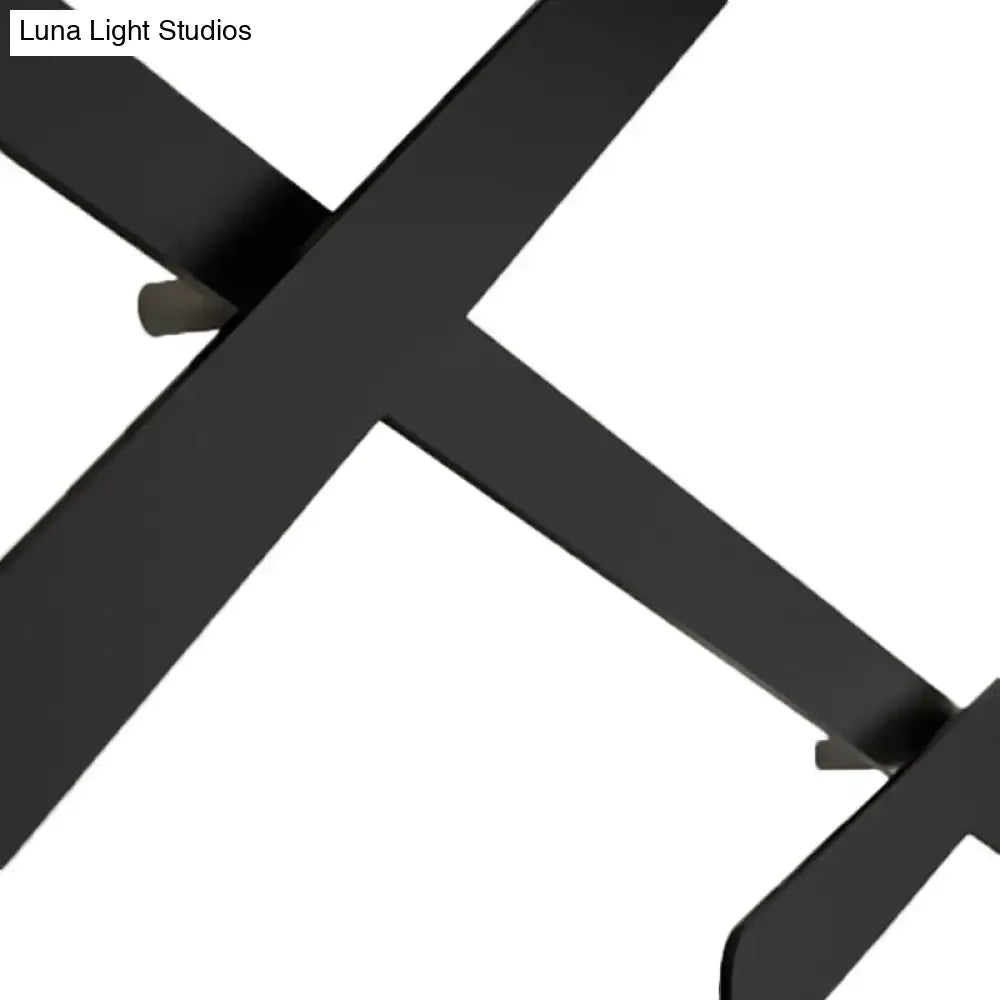 Modern black wall light with x-shaped matte metal leg and bulb included featuring a sleek bulb base design